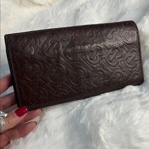 Burberry TB Monogram bi-fold long leather wallet in brown.
